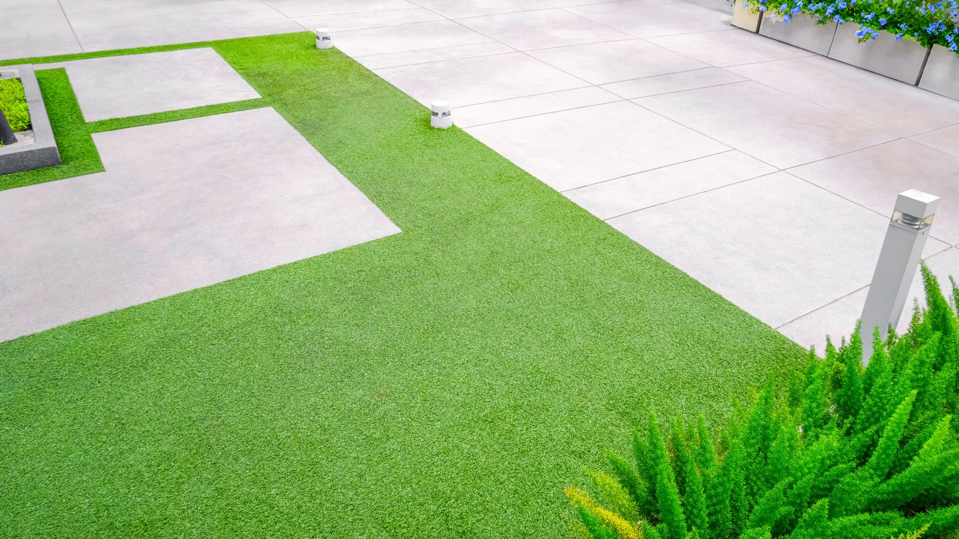 Artificial turf with gravel stone pavement decoration and ornamental plant in Home Gardening area